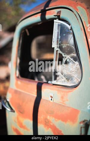 Broken glass window on old abandoned vehicle Stock Photo