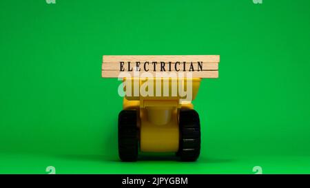 The word electrician is written on wooden sticks. Business machine concept. job occupations. Stock Photo