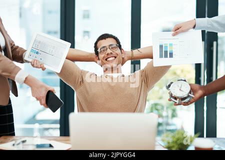 I do my best when the heat is on. a young businessman looking calm in a demanding office environment. Stock Photo