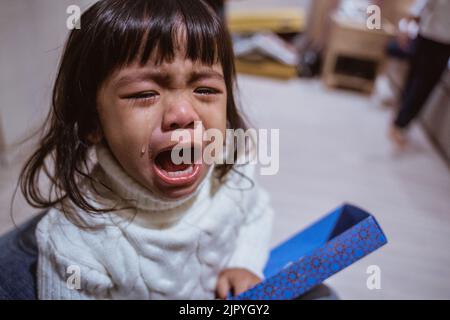 toddler crying with tear running down her cheek Stock Photo