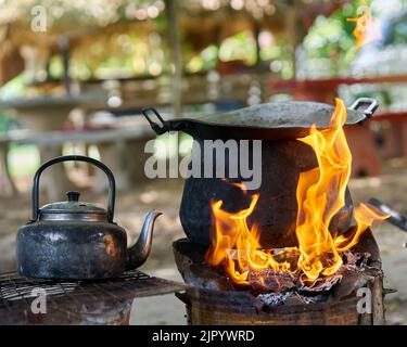 https://l450v.alamy.com/450v/2jpywrd/a-big-black-pot-and-old-kettle-on-an-outdoor-fire-2jpywrd.jpg