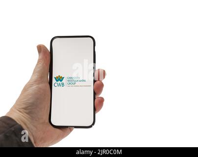 Cardiff Mid Glamorgan UK August 20 2022 person holding cellphone with Canadian Western Bank Group Logo on a white background Stock Photo