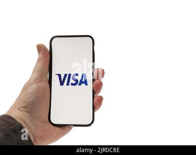 Cardiff Mid Glamorgan UK August 20 2022 person holding cellphone with  Visa  Logo on a white background Stock Photo
