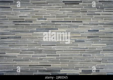 Background from a wall made of small gray granite tiles Stock Photo