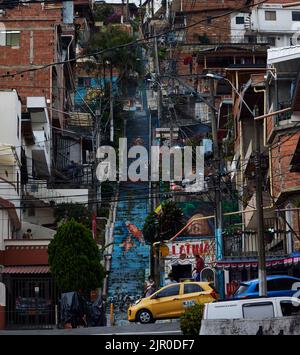A vertical shot of stairs with street art at the Comuna thirteen in Medellin, Colombia Stock Photo
