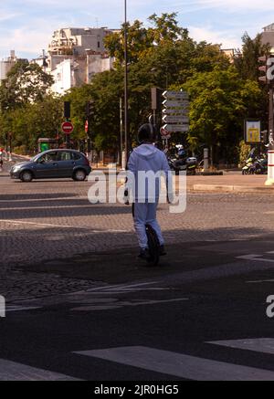 Paris, France - July, 14: Man riding fast on electric unicycle the Mobile portable individual transportation vehicle on city street on 14 July, 2022 Stock Photo