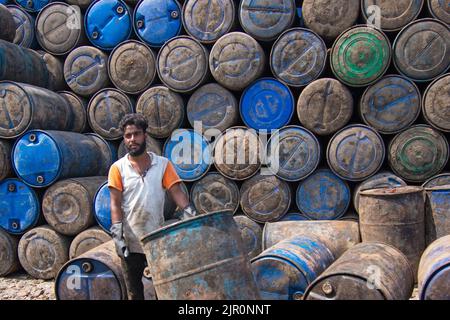 Narayanganj, Dhaka, Bangladesh. August 21, 2022, Narayanganj, Dhaka, Bangladesh: Colorful oil drums are stacked in rows by workers in a warehouse in Narayanganj, Bangladesh. The colorful containers which can hold about 250 liters of oil are used for storing fuels including petrol, diesel and octane. Even as people are grappling with rising inflation amid the Russia-Ukraine war, the Bangladesh government has raised fuel oil prices as much as 51.68%, citing a global hike. Credit: ZUMA Press, Inc./Alamy Live News Stock Photo