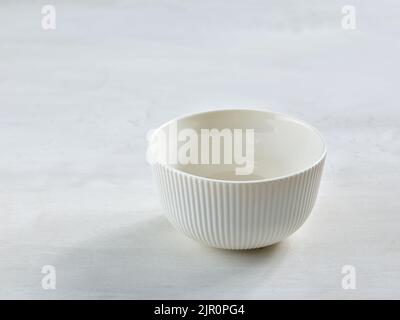 empty white bowl on white kitchen table Stock Photo