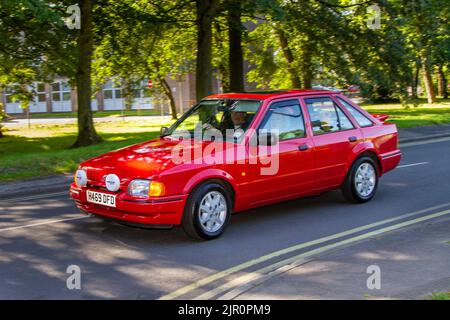 1990 90s nineties red FORD Escort Ghia 1392cc 5 speed manual saloon; Vintage motors, and cars on display at the 13th Lytham Hall Summer Classic Car & Show, a Classic Vintage Collectible Transport Festival, Blackpool, UK Stock Photo