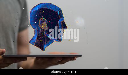 A blue digital human head floating on a tablet - artificial intelligence and creativity concept Stock Photo