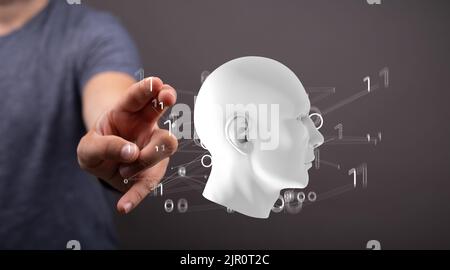 A hand pointing at a digital human head connected to numbers - an artificial intelligence concept Stock Photo