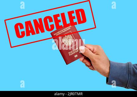 Russian foreign passport in the hands of a man. Prohibition of Schengen visas for Russian tourists to travel to the European Union concept. High quality photo Stock Photo