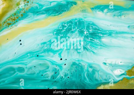 Abstract fluid acrylic painting. Marbled blue abstract background. Hand painted background with mixed liquid blue and green paints. Liquid marble Stock Photo