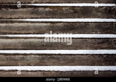 Slate background with snow lying on it. Stock Photo