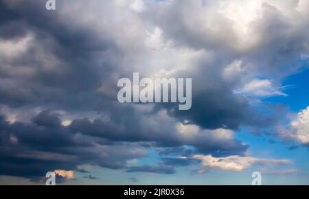 Beautiful dark stormy clouds on a blue sky before a thunderstorm Stock Photo
