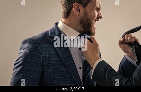 Experiencing aggression at work. Angry professional man fight with colleague. Workplace aggression Stock Photo