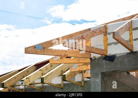 Roof trusses connected to the roof truss, not covered with a roof, with a steel I-beam instead of a corner rafter. Stock Photo