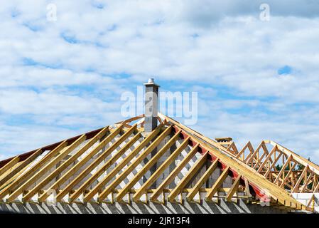 Roof trusses connected to the roof truss, not covered with a roof, with a steel I-beam instead of a corner rafter. Stock Photo