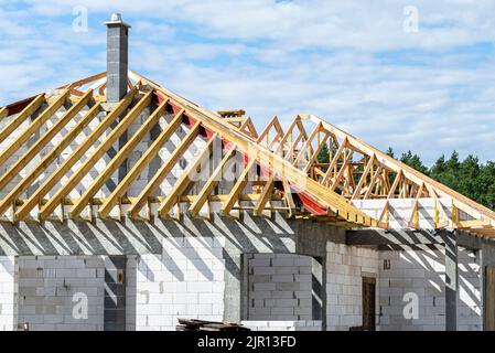 Roof trusses connected to the roof truss, not covered with a roof, with a steel I-beam instead of a corner rafter. Stock Photo