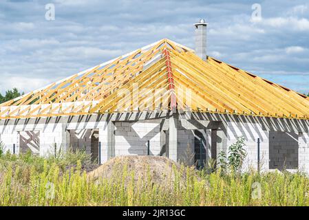 Roof trusses connected to the roof truss, not covered with a roof, with a steel I-beam instead of a corner rafter. Stock Photo