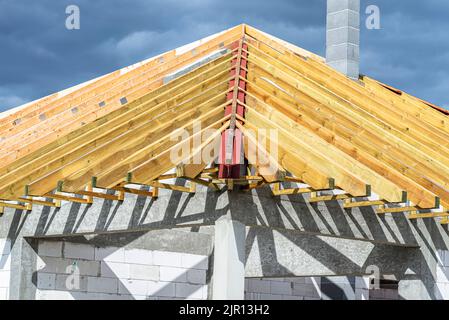 Roof trusses connected to the roof truss, not covered with a roof, with a steel I-beam instead of a corner rafter. Stock Photo