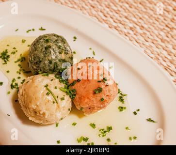 cheese dumpling, spinach dumpling and beetroot dumpling - South Tyrolean traditional food Stock Photo