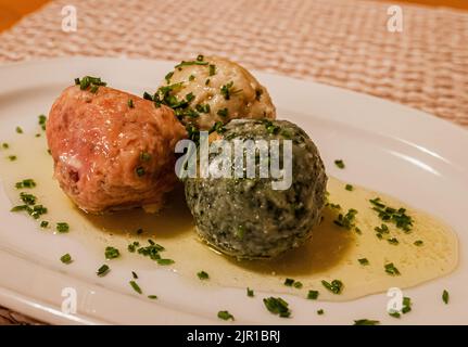 cheese dumpling, spinach dumpling and beetroot dumpling - South Tyrolean traditional food Stock Photo