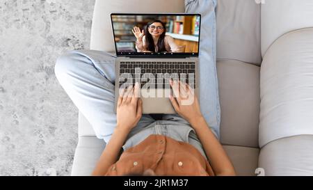 Virtual Communication. Unrecognizable woman making online video call with female friend Stock Photo