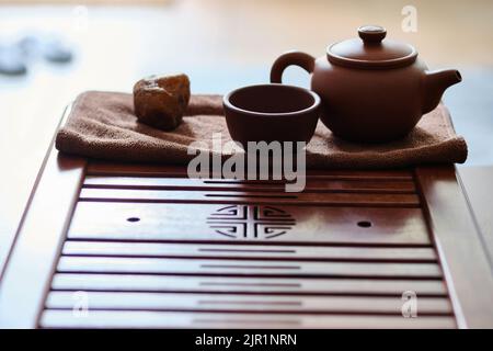Chinese yixing clay teaware at bamboo tea tray Stock Photo