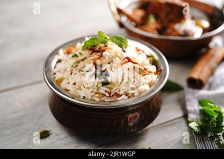 Malabar Ghee Rice or Nei choru with chicken curry, selective focus Stock Photo