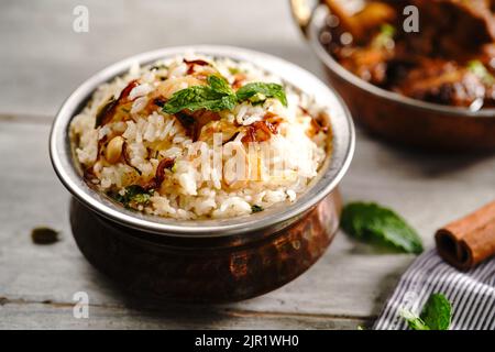 Malabar Ghee Rice or Nei choru with chicken curry, selective focus Stock Photo
