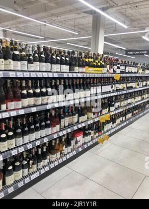 19.08.2022, Ukraine, Kharkiv, a large selection of wines of different varieties on the supermarket shelf Stock Photo