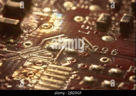electronic background: Internal components of a printed circuit with solders and various components. Stock Photo