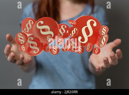 A female's hands holding 3D paragraph symbols of law Stock Photo