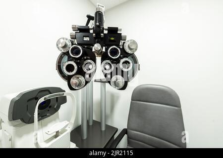 Vision measuring device in a cubicle with a seat for the patient Stock Photo