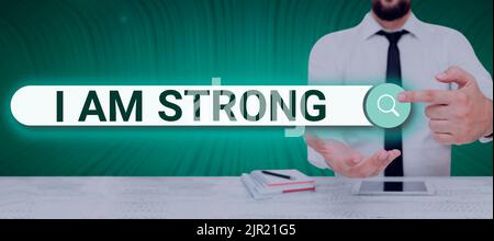 Text caption presenting I Am Strong. Business overview Have great strength being healthy powerful achieving everything Man Holding A Tablet Projecting Stock Photo