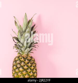 Fresh pineapple on on bright pink background. Flat lay Stock Photo