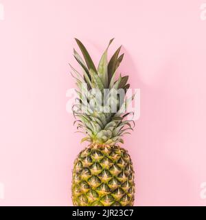 Fresh pineapple on on pastel pink background. Flat lay Stock Photo