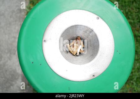 Close up burning cigarette in ashtray on table  Stock Photo