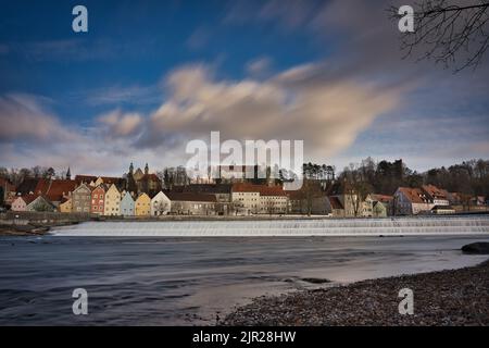 A beautiful view of buildings with a river in the foreground in Landsberg am Lech Stock Photo