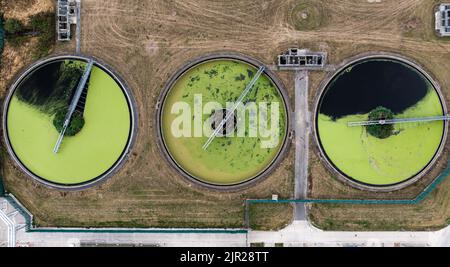 An aerial view directly above a waste water treatment works with ...