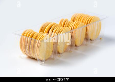 Round Crackers biscuits in plastic box isolated on white background, Dry cracker cookies isolated, snack and fastfood concept Stock Photo