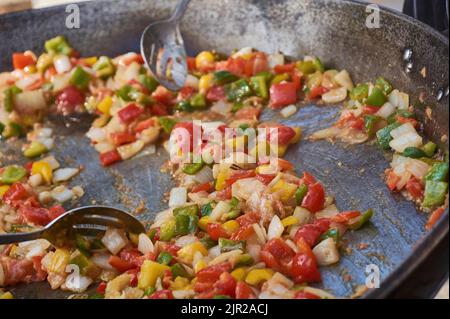 Frying pan full of vegetables that cook for the preparation of the sauce: An example of how you can cook vegetables to make a tasty sauce. Stock Photo