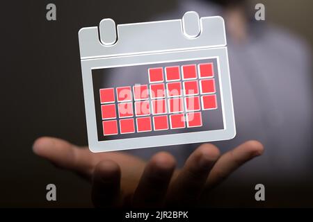 A 3d rendering of floating calendar on a palm of a hand Stock Photo