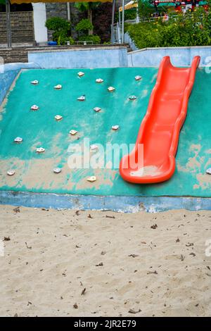 Play sand pool and slides in children's playground Stock Photo