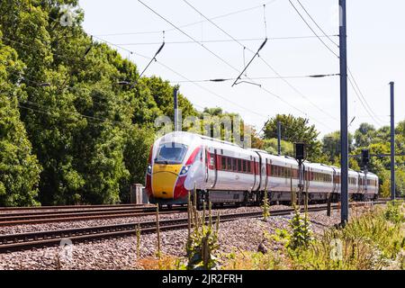 Azuma diesel electric train of the London North Eastern Railway, LNER, passes Offord Cluny on the East Coast Main Line, heading North. Stock Photo