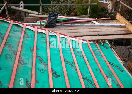 An untitled roof showing the wooden beams and roofshield covering Stock Photo