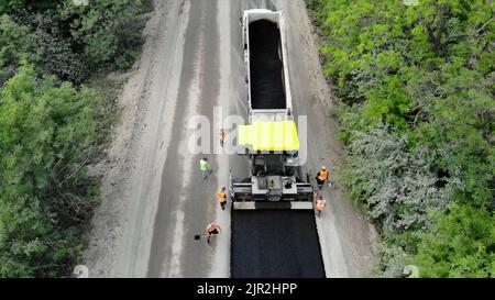 Aerial view on repair of a highway, the process of laying a new asphalt covering, Road construction works. High quality photo Stock Photo