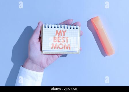 Writing displaying text My Best Mom. Word for Admire have affection good feelings love to your mother Woman Holding Notepad With Important Message On Stock Photo