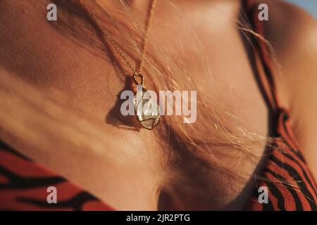 Gemstone necklace on young woman's neck, gemstone necklace, in the sunlight, selective focus Stock Photo